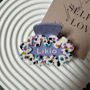 Pinza per capelli geometrica a onde in acetato viola con motivi in pietra colorata