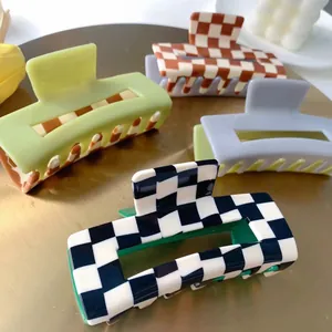 Checkerboard and pastel matte hair claws in mint, lilac, and brown patterns