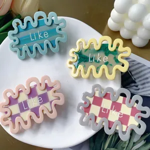 Set of wavy acetate hair clips with vibrant floral and checkered patterns and Like text