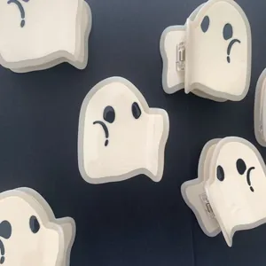 Detailed view of white ghost-shaped acetate hair claws for Halloween hair accessories