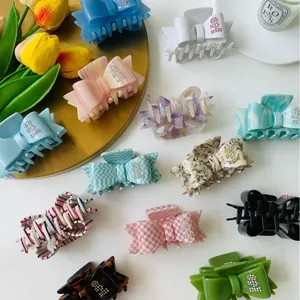 Bow hair claws set with rhinestones and acetate patterns on a stylish vanity setup