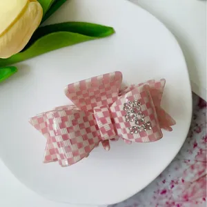 Pink checkered bow claw clip with rhinestones and acetic acid finish for women