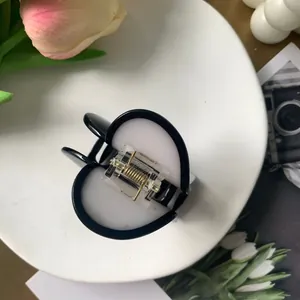 Minimalist black and white heart-shaped acetate hair claw clip for women's daily hair styling