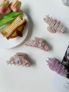 Detailed set of five acetate hair claws with floral patterns, pearls and crystals