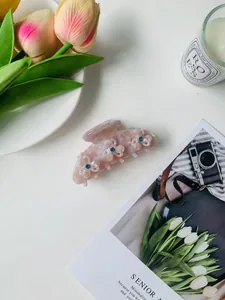 Pink marble pattern hair claw with white 3D flowers and blue rhinestone details