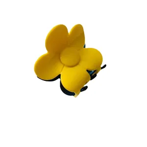 Elegant yellow flower claw clip with a matte finish and five-petal floral design