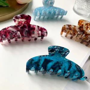 9cm acetate hair claw clips with marble and floral patterns on white background