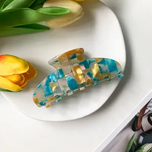 Large 9cm checkerboard acetate hair claw clip styled with fresh yellow tulips