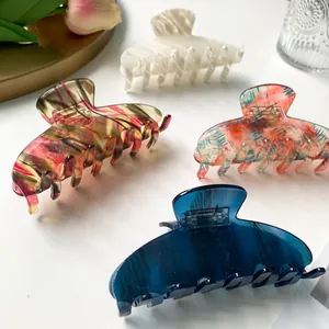 Set of four minimalist acetate hair claws in white, blue, and patterned styles