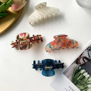 Elegant large acetic acid hair claws in marble and artistic patterns for women's hairstyling