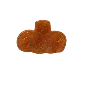 Halloween pumpkin hair claw in orange acetate with golden glitter and celestial patterns