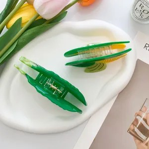 Creative corn and cucumber shaped hair claws on a decorative white porcelain plate