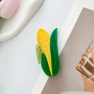 Detailed view of realistic corn-shaped hair claw clip with glossy yellow and green finish