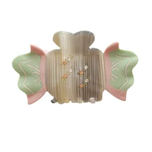 Elegant acetate hair claw clip with colorful rhinestones and candy-colored striped design
