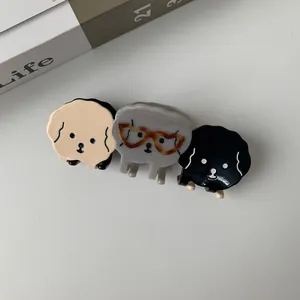 Detailed set of three cute puppy hair claws in cream, grey and black acetate finish