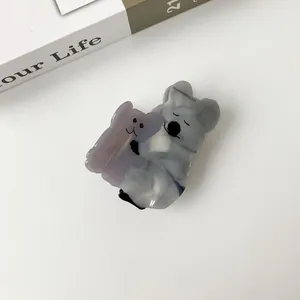 Detail view of acetate koala hair claw clip with grey marble texture on white background