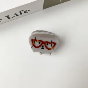 Close-up of cute grey acetate puppy hair claw clip with heart-shaped glasses
