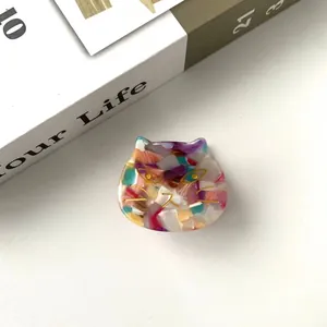 Macro detail of cat-shaped acetate hair claw clip with colorful floral pattern