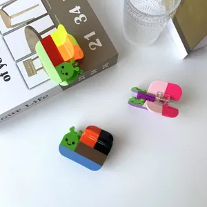 Cute snail-shaped hair claw clips in vibrant color-blocking designs for hair styling