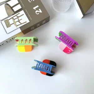 Three colorful wavy hair claws in contrasting matte shades for chic hair styling
