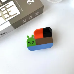 Close-up of a colorful snail-shaped hair claw clip made of glossy acetate material