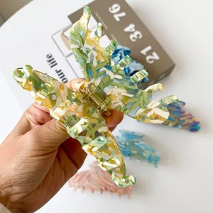 Large acetate butterfly hair claw clip with marble texture for elegant hairstyling