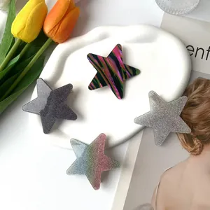 Sparkly star-shaped acetate hair clips set with glitter and colorful striped patterns