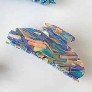 Close-up of marble pattern acetate hair claw clip with colorful floral texture detail