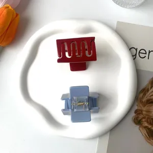 Chic burgundy and pale blue rectangular hair claws on a decorative white tray