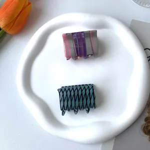 French handmade acetate hair claws in purple stripes and blue grid patterns
