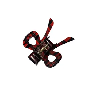 Plaid bow hair claw clip in red and black tartan pattern with gold spring mechanism