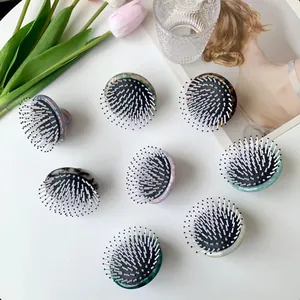 Chic acetate massage hairbrushes with marble and tortoiseshell patterns in diverse colors