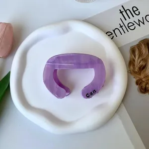Purple marble acetate hair claw clip with Can lettering on white tray and flowers