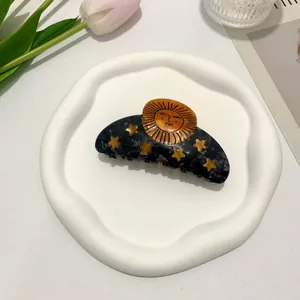 Celestial acetate hair claw with sun and stars pattern in marble dark grey and gold