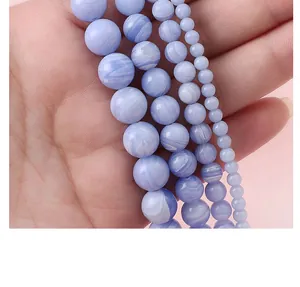 Macro detail of Blue Lace Agate beads showing natural white wave patterns and polished finish