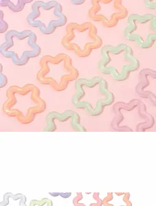 Close-up of colorful acrylic star-shaped connectors in pastel macaron shades for DIY jewelry