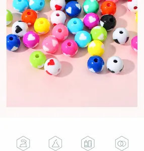 Close-up of colorful acrylic beads with heart patterns for DIY jewelry making