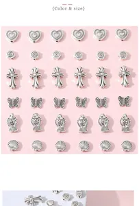 Macro view of vintage silver alloy charms featuring heart flower and butterfly patterns