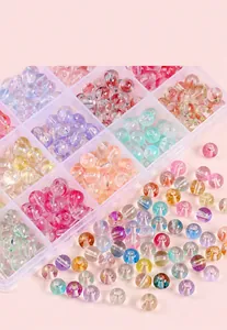 Close-up of 8mm jelly bubble glass beads in a multi-grid storage box for DIY jewelry
