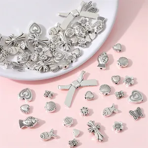 Antique silver alloy charms collection with heart, flower, and butterfly for DIY jewelry making