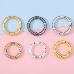 Set of six colorful metal spring O-rings for DIY bags and keychains on pastel background