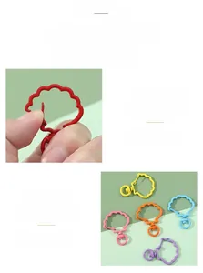 Macro shot showing the colorful lacquer finish and swivel clasp on metal shell charms