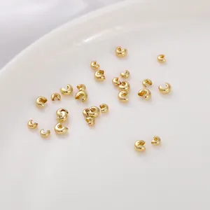 Macro shot of 14K gold filled C-shaped crimp bead covers for jewelry making