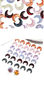 Macro view of assorted crescent glass beads with pre-drilled holes for DIY jewelry