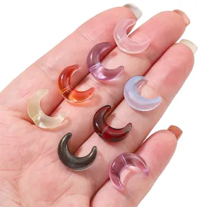 Handheld assorted crescent moon glass beads in eight vibrant colors for DIY jewelry making