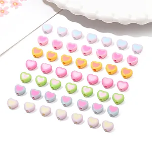 Close-up of colorful acrylic heart beads for DIY jewelry making in pastel macaron tones