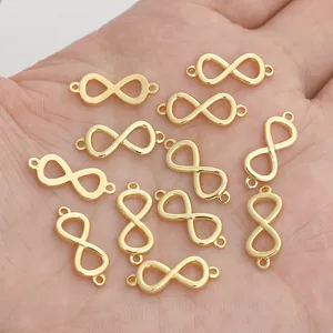 Hand holding 14K gold plated infinity link connectors for DIY jewelry making