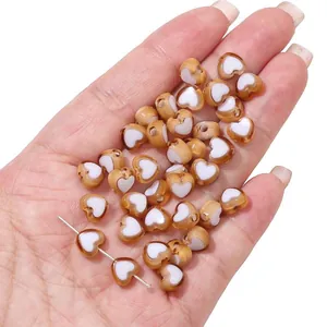 Two-tone acrylic heart beads in amber and white for DIY jewelry making and bracelets