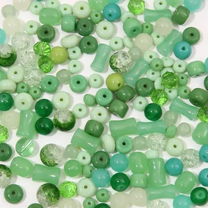 Macro shot of assorted green glass crystal beads in round and faceted shapes for DIY jewelry