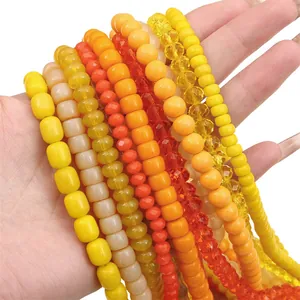 Assortimento di perle di vetro arancione e giallo tonde e sfaccettate per gioielli DIY